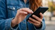 © Stock Spectrum - Close-up view of a woman using a mobile smartphone device in her hands.