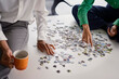 © BusinessClass by W61 - Business colleagues solve a jigsaw puzzle in a London boardroom