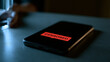 © Momin Photo Gallery - Elegant photo of A red censored stamp on a smartphone screen resting on a dark table. This represents digital media restriction and internet freedom concerns.