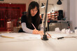 © Milles Team/Stocksy - Young woman drawing sketches at creative studio office