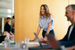 © OchreOchre/Stocksy - Woman Leading Informal Business Team Meeting