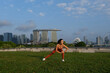 © Eyes on Asia/Stocksy - Woman stretching before workout in Singapore