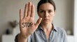 © Spot Decor - Closeup of a woman's hand with the word STOP written to reject harassment and set boundaries.
