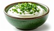 © KASUEMA SALAE - Green ceramic bowl filled with sour cream topped with chopped green onions, isolated on white background, creamy texture, gourmet food styling