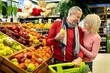 © Prostock-studio - Smiling Elderly Caucasian Man And Woman Enjoying Shopping Together In Modern Supermarket, Selecting Fresh Organic Fruits, Holding Basket, Happy Expression, Lifestyle Concept, Retail Environment.