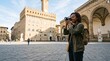 © Azor - Young Black Woman Tourist Capturing Photos of Historic Palazzo Vecchio in Florence Italy