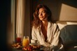 © Alexei - Young woman with long dark hair wearing a white bathrobe sits on a bed, enjoying breakfast with fruit, juice, and coffee in a sunlit hotel room