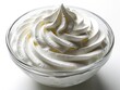 © Vadym - Whipped cream texture forms soft swirls inside clear glass bowl. Light airy dairy topping looks fluffy and smooth. Food background for desserts cakes or pies.