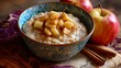 © Mitchell - Creamy oatmeal bowl with warm cinnamon apples sits in rustic earthenware, offering a delicious concept for healthy breakfast recipes