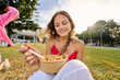 © Alvaro Lavin/Stocksy - Young woman enjoying healthy pasta salad lunch outdoors