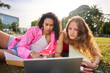 © Alvaro Lavin/Stocksy - Diverse students studying together outdoors with laptop