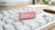 © PhanDesigns - Modern computer keyboard featuring a bright pink Contact Us button.