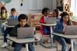 © Home-stock - Students using laptops individually during lesson in classroom
