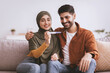 © Prostock-studio - Smiling Middle Eastern Couple Celebrating Positive Pregnancy Test Together At Home, Embracing Each Other In Joyful Moment, Sharing Anticipation For New Family Member In Cozy Living Room.