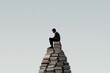 © Antony - Creative pose on a large stack of books