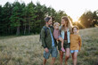 © Halfpoint - Family hiking together through countryside during summer camping trip.