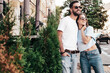 © halayalex - Smiling beautiful woman and her handsome boyfriend. Woman in casual summer jeans clothes. Happy cheerful family. Female having fun. Sexy couple posing in the street at sunny day. In sunglasses