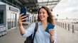 © Тоха Шикула - Joyful traveler capturing a selfie at the airport prior to departure
