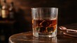© BlackBird Studio - Glass of Whiskey with Ice on Wooden Bar Table