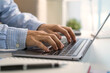 © NaMong Productions - Business professional typing on laptop for digital workflow remote work online communication data management business planning multitasking and modern office productivity.