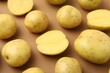 © New Africa - Ripe raw young potatoes on light brown background, closeup