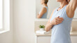 © Creative Valley - Woman performing breast self examination in front of mirror, checking breast health at home, representing breast cancer awareness, early detection, prevention, healthcare screening and wellness
