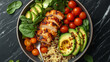© pavlovski - Overhead gourmet shot of a healthy protein power bowl with grilled chicken, quinoa, sliced avocado, and cherry tomatoes on a dark marble surface