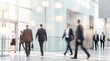 © Anna - Business professionals walking through a modern glass entrance of a corporate building. Perfect for corporate brochures, business blogs, and web headers.