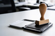© Kazeon - Wooden handled rubber stamp resting beside an open ink pad