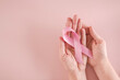 © SewcreamStudio - hands holding pink ribbons, Breast cancer awareness and October Pink day, world cancer day
