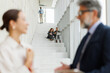 © Westend61 - Employees working and talking on modern office staircase
