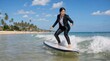 © Iqbal - Businesswoman surfing in suit on beach