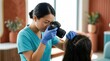 © Megin Design - Medical professional photographing patient's hair and scalp for clinic records. Dermatologist examining head for diagnosis of skin condition