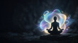 © Constantin - Silhouette of person meditating with glowing colorful energy aura and copy space on dark background