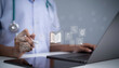 © Toowongsa - Doctor using digital learning technology with laptop showing education icons open book research training knowledge healthcare professional development online medical education and virtual learning