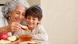 © xuxu - Grandmother and grandson celebrating rosh hashanah, dipping apple into honey. Jewish new year tradition for sweet blessings, multi-generational family bonding. Horizontal composition with copy space.