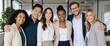 © Viktoryia - six smiling corporate professionals standing together with arms around each other and looking at camera in modern office