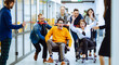 © maxbelchenko - Group of office colleagues cheerfully greets person sitting on chair as they are wheeled down hallway. Happy employees riding chairs in a bright corridor. Concept of office staff, workplace fun.