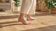 © OHMAl2T - Barefoot person walking on wooden floor in bright cozy home interior sunlight