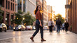 © Awan - A young woman with dark hair, smiling, walking on a sidewalk next to a street with blurred cars and buildings. The sun is setting, casting a warm golden light on the scene.