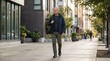 © Dialova Creative - A confident and mature man walking purposefully along a modern urban neighborhood sidewalk, enjoying a casual stroll through the city environment on a bright day