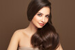 © Oleg Gekman - Brunette girl with perfect makeup. Smiling beautiful model woman with long curly hairstyle. Care and beauty hair products
