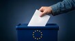 © Humaira - Hand placing a ballot paper into a blue European Union voting box.