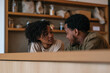© Milos - A couple shares a tender moment while preparing a meal, showing the emotional connection accompanied by companionship and the joy of culinary experiences together.