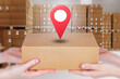 © Grispb - Parcel delivery logistics. Customer receives a cardboard package from a courier, with location pin symbolizing shipment tracking and delivery address.