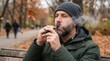 © HIJRAH - Man Vaping Outdoors In Fall Park With Falling Leaves