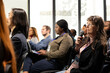 © DC Studio - Senior woman in the audience uses a microphone to ask questions and join a business panel discussion during a conference summit and training event.