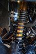 © ADDICTIVE STOCK - Close-up of motorbike rear shock absorber and suspension