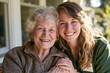 © limanskaya - Elderly woman with gray hair smiles alongside a young woman with curly hair, both seated outdoors in a sunlit garden setting, showcasing a warm and caring relationship
