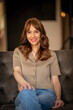 © sepy - Portrait of smiling mature woman sitting on couch at home